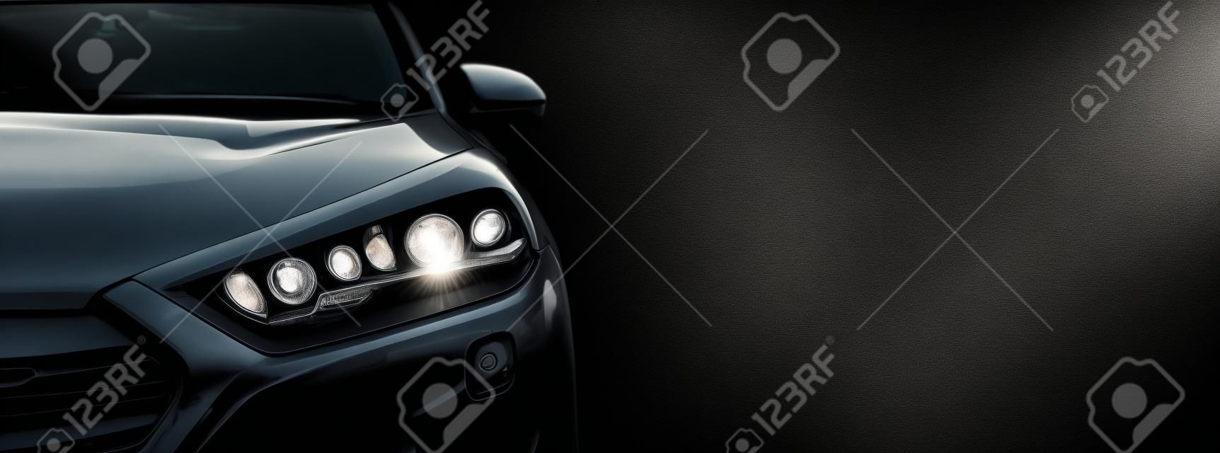 Gray modern car closeup on black background.