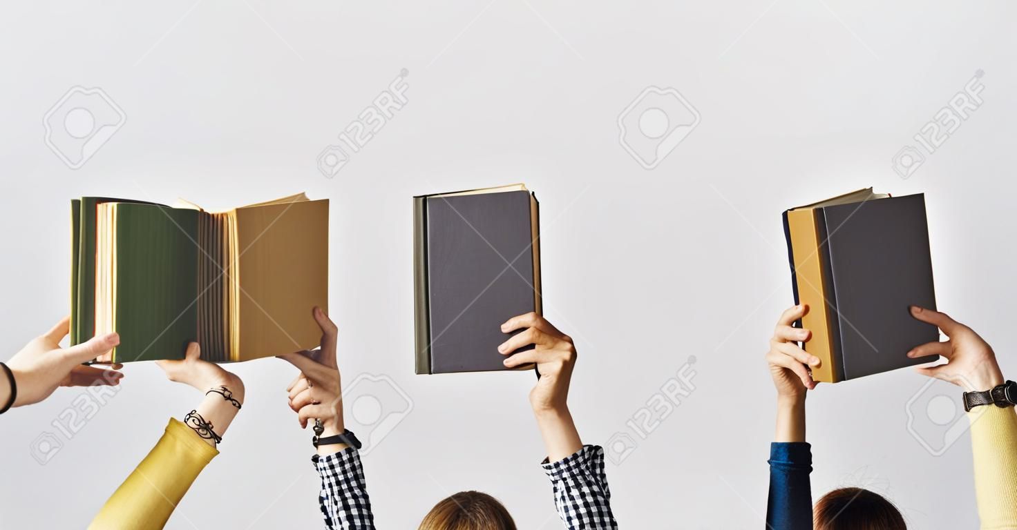 The hands of people hold books