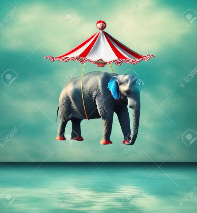Fanciful and artistic image that represent a flying elephant with circus tent above the water