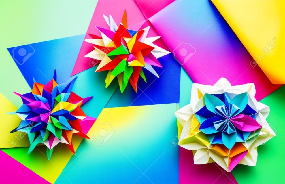 Colorfull origami kusudamas on bright paper background