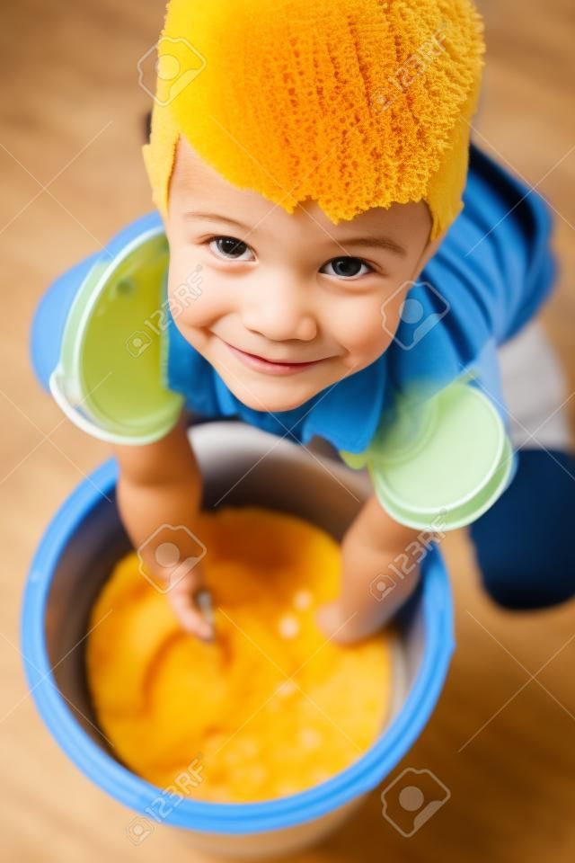 Cute boy with bucket and sponge, closeup