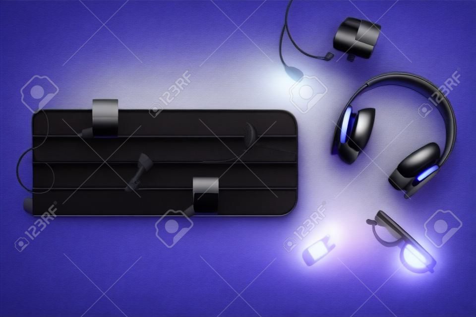 Modern headphones with video camera and music staff on color background