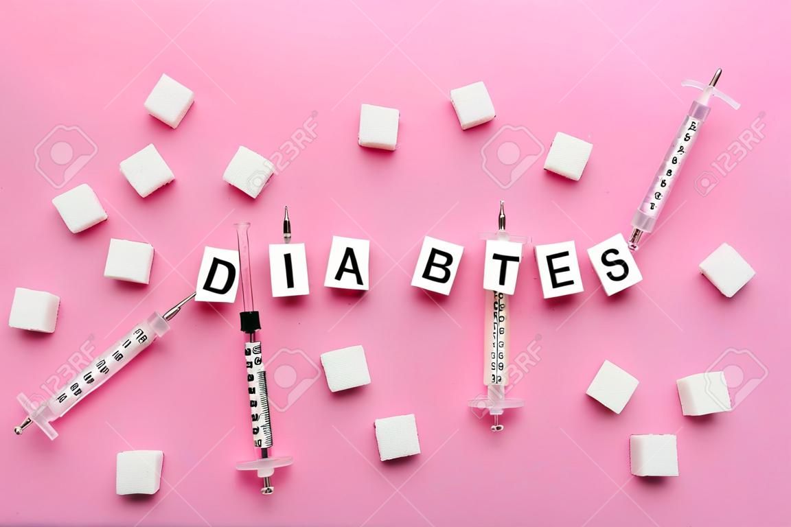 Sugar, syringes and word DIABETES on color background