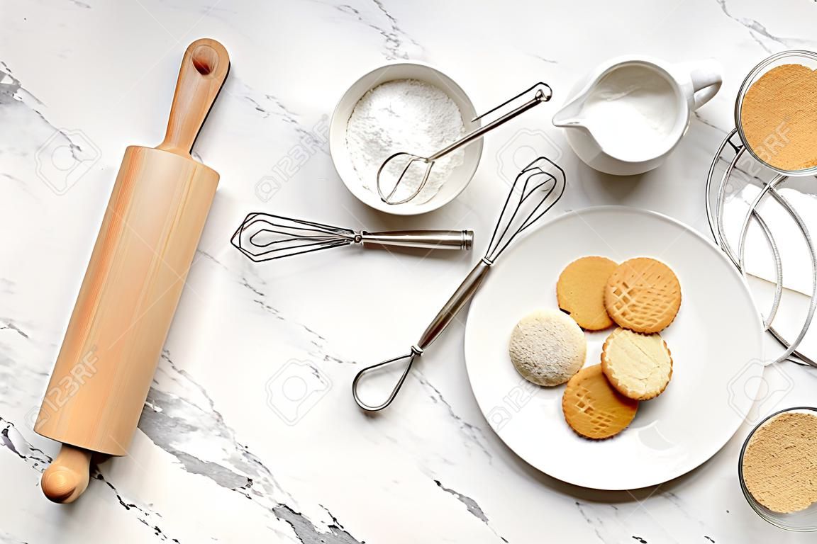 Ingredients for cookies and rolling pin on light background
