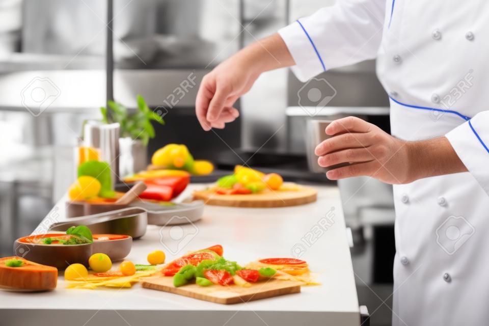 Mature chef cooking in kitchen, closeup