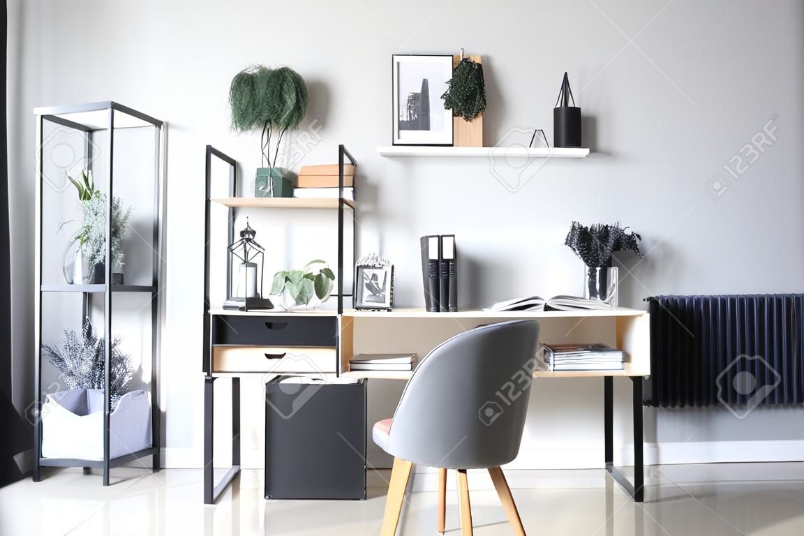 Modern workplace and book shelf with decor in interior of room