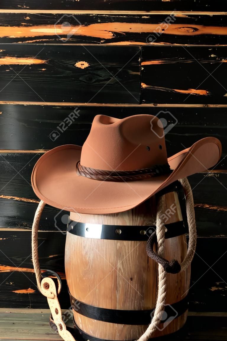Cowboy hat, lasso and horseshoe on wooden background
