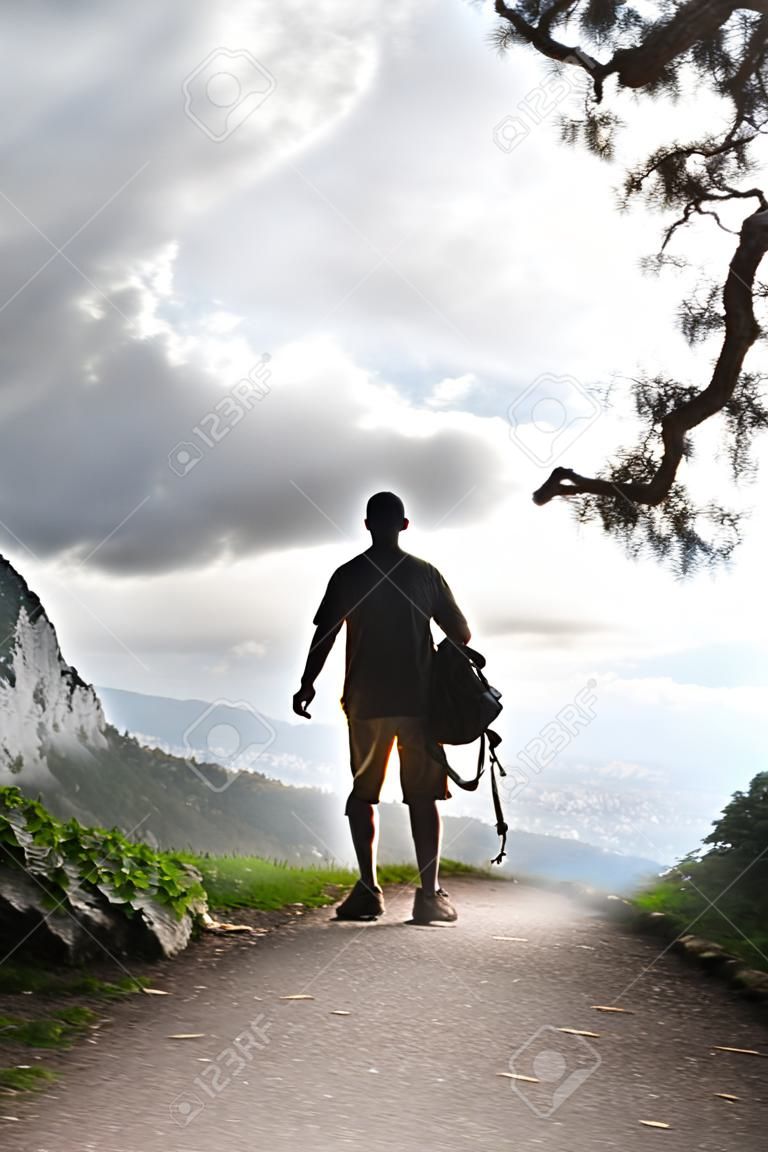 Silhouette of tourist and a beautiful landscape as a backdrop