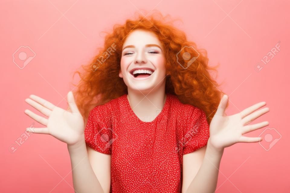 Happiness, celebration and beauty concept. Alluring carefree caucasian cute redhead girl with curls, close eyes cheering having fun, smiling broadly embrace hands enthusiastic, white background