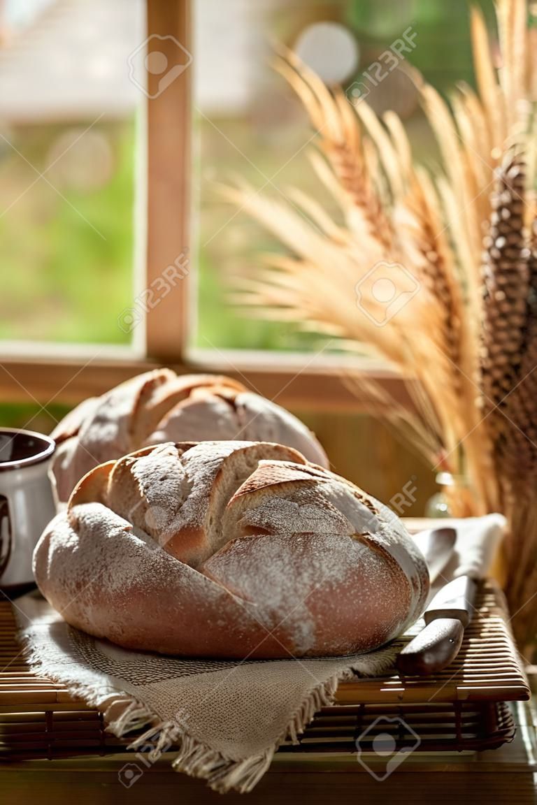 Healthy loaf of bread in rustic kitchen with coffee