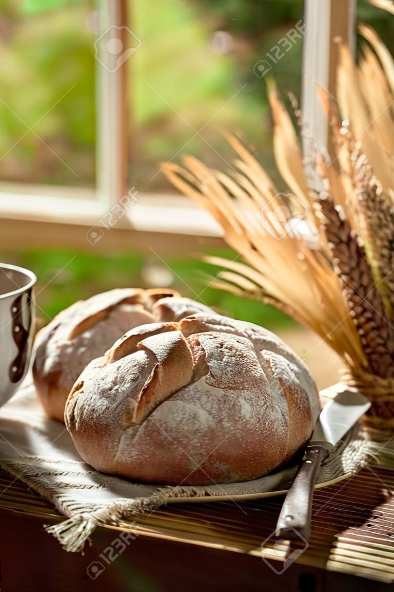 Healthy loaf of bread in rustic kitchen with coffee