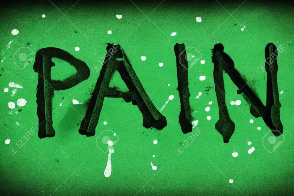 Le mot douleur peint par de la peinture verte sur une vieille table en métal