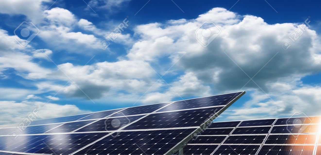 Solar fotovoltaica paneles de campo para la producción de energía renovable con el cielo azul y las nubes