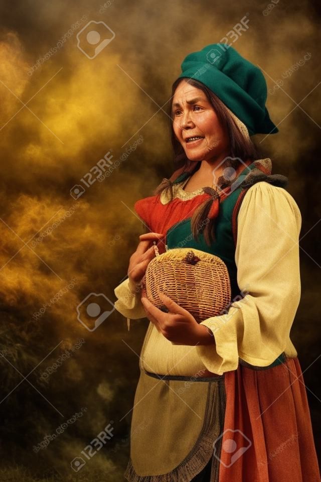 Femme paysanne cuisiner un repas de fête au jour de la récolte. Image stylisée rétro. sur fond de pelouse