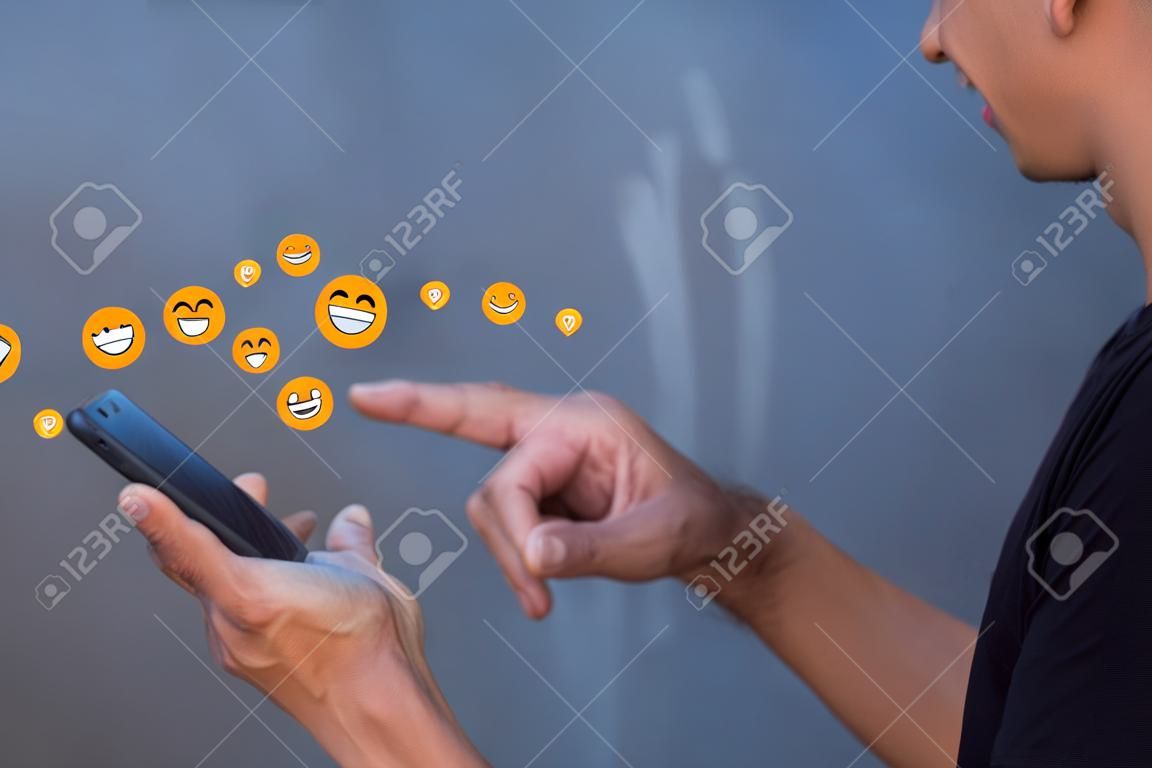 Concept of happy using digital media, technology, social media online surfing, male hand using smartphone To use social media, the concept of working remotely, working from home via the Internet