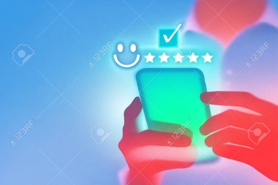 Satisfaction and customer service survey concept, business people using  smartphone. to answer the questionnaire And the satisfaction rating, the satisfaction rating with the smiley face icon 5 stars.