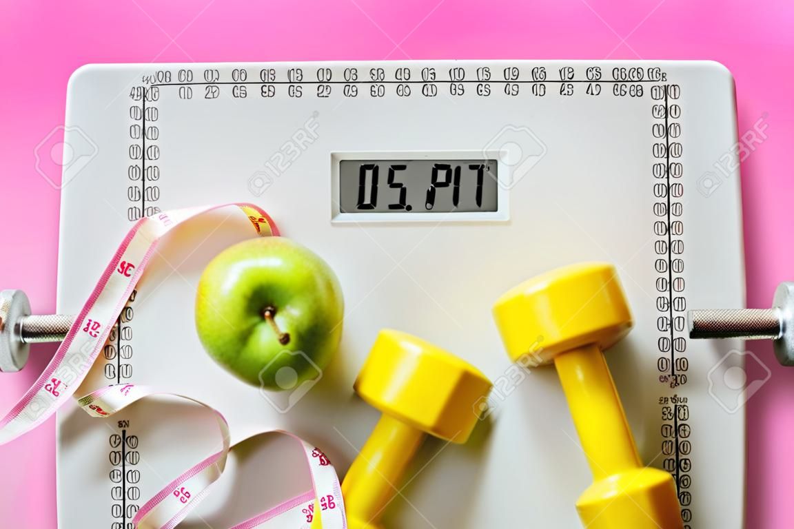 fruit, dumbbell and scale, fat burn and weight loss concept, diet