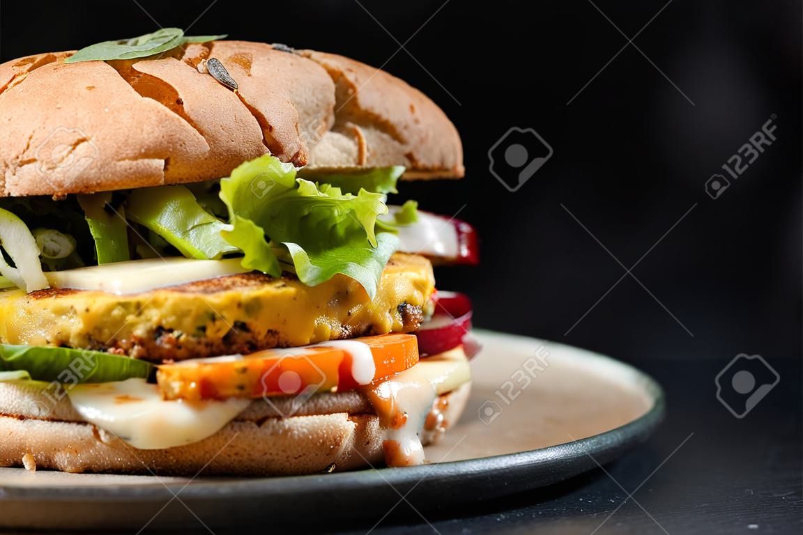 Huge veggie burger with potato patty, salad, cheese.