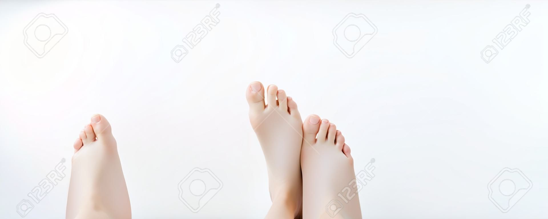 Beautiful female a foot and a heel on a white background