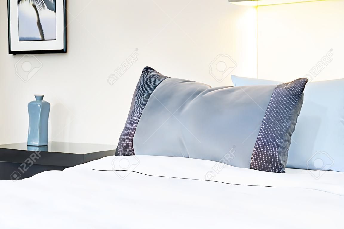 Beautiful luxury comfortable pillow on bed with light lamp decoration in bedroom interior