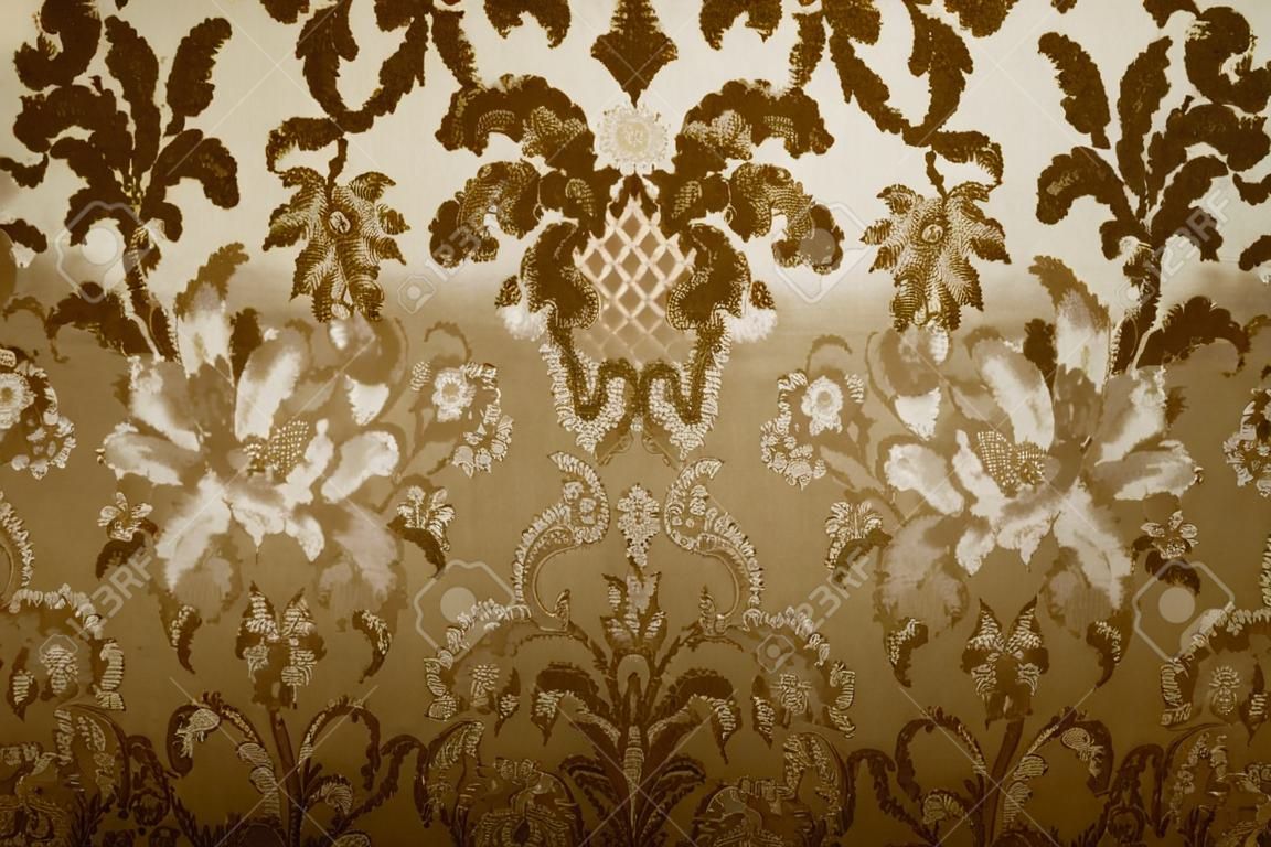 old upholstery fabric with floral motif in sepia tone 