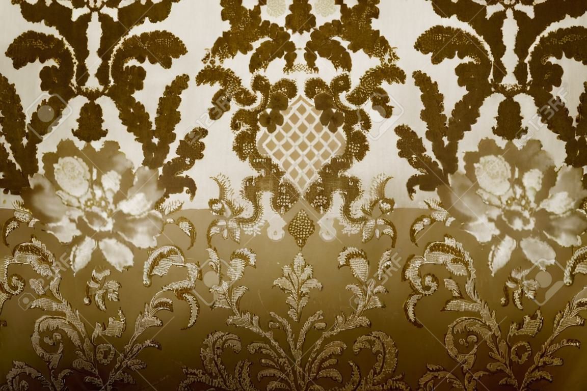 old upholstery fabric with floral motif in sepia tone 