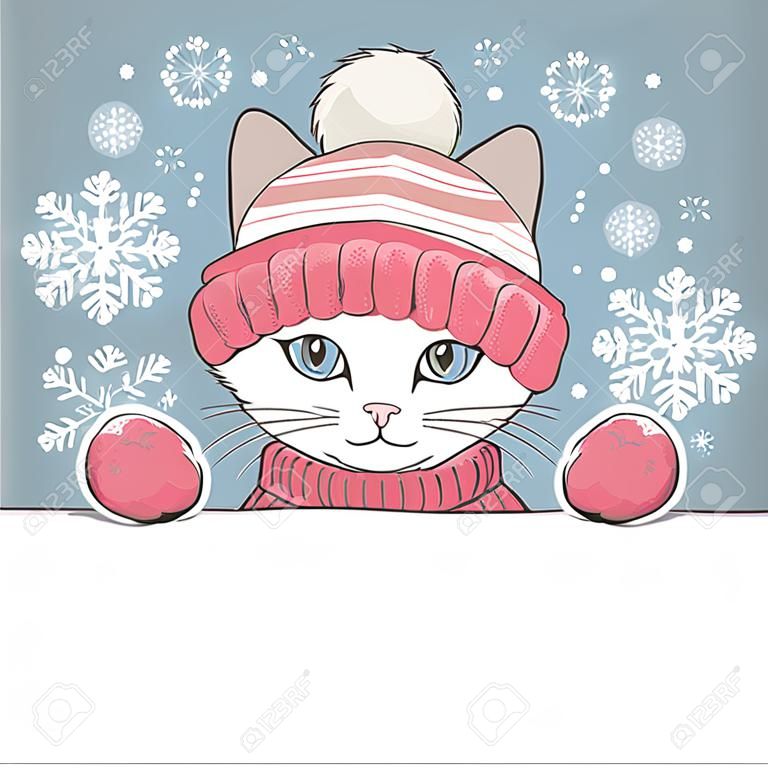 Ładny kotek ma na sobie czapkę i rękawiczki z ornamentem.