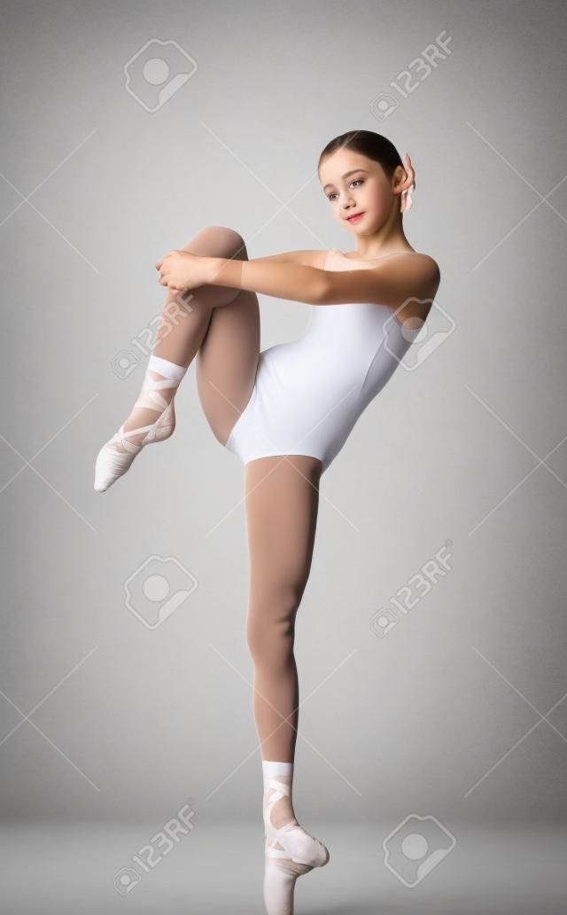 Portrait of cute teen ballet dancer girl isolated on white