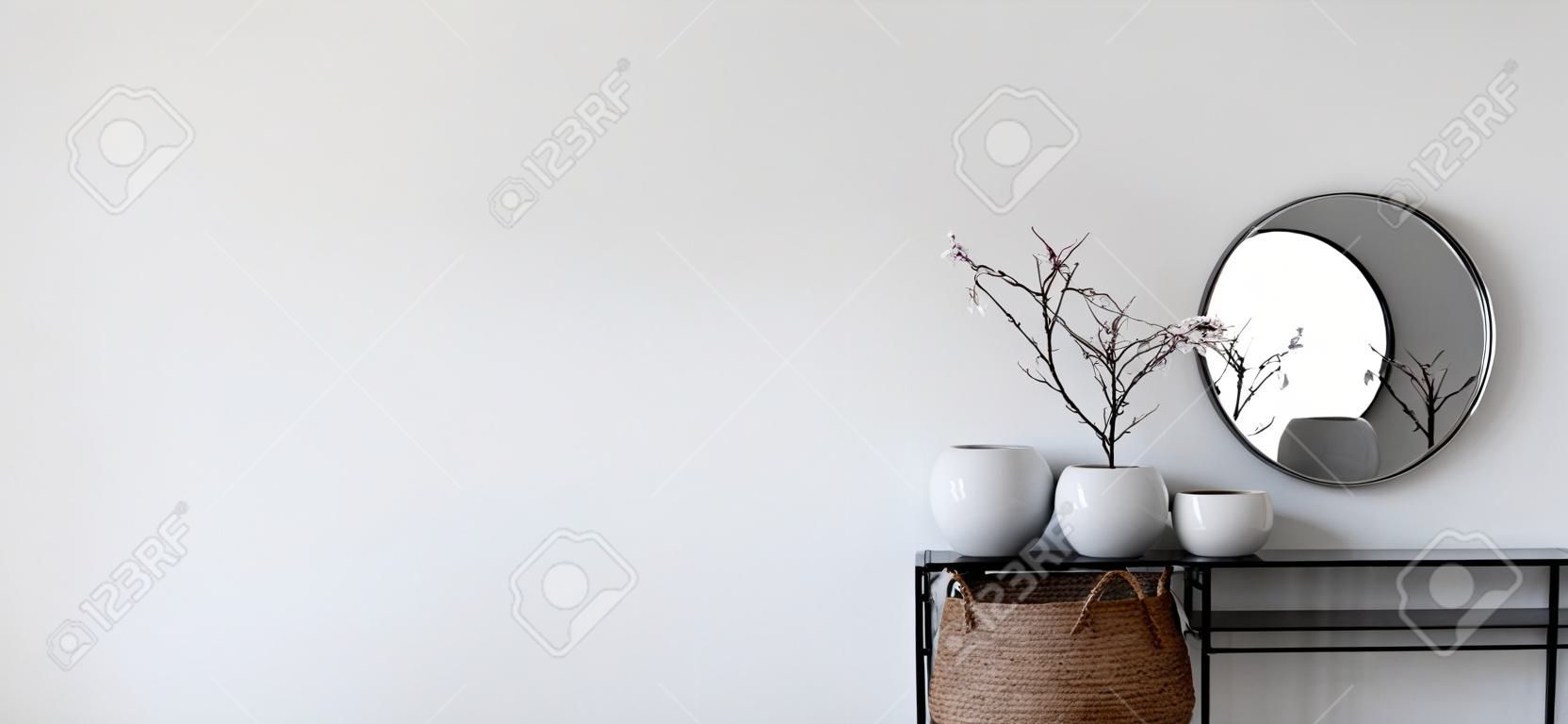 Single modern black display holding up mirror and potted plants in front of white wall. Includes copy space. 3d rendering