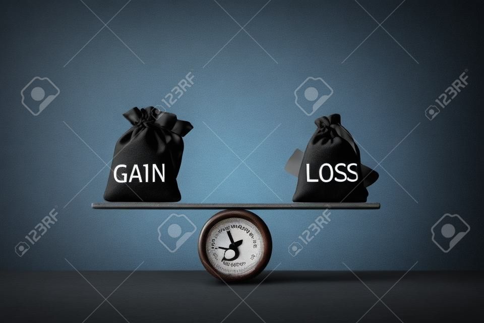 Gain and loss bags on a basic balance scale on blackboard. Capital investment gain and loss, financial concept, depicts balancing between profit and loss while managing assets e.g bonds, stocks, derivatives, ETFs