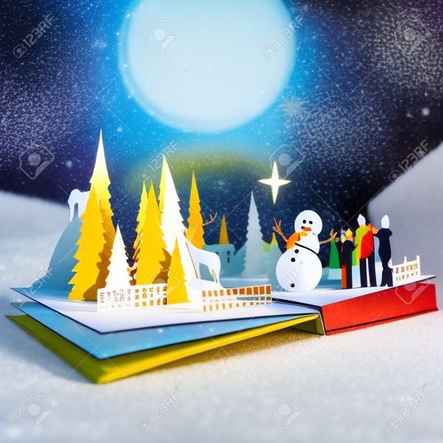Pop-up-Buch - Christmas Story. Stil 3D-Pop-up-Buch mit einem chrsitmas Thema darunter eine Familien-Schneemann bauen, Winterwald und Sterne. Illustration.