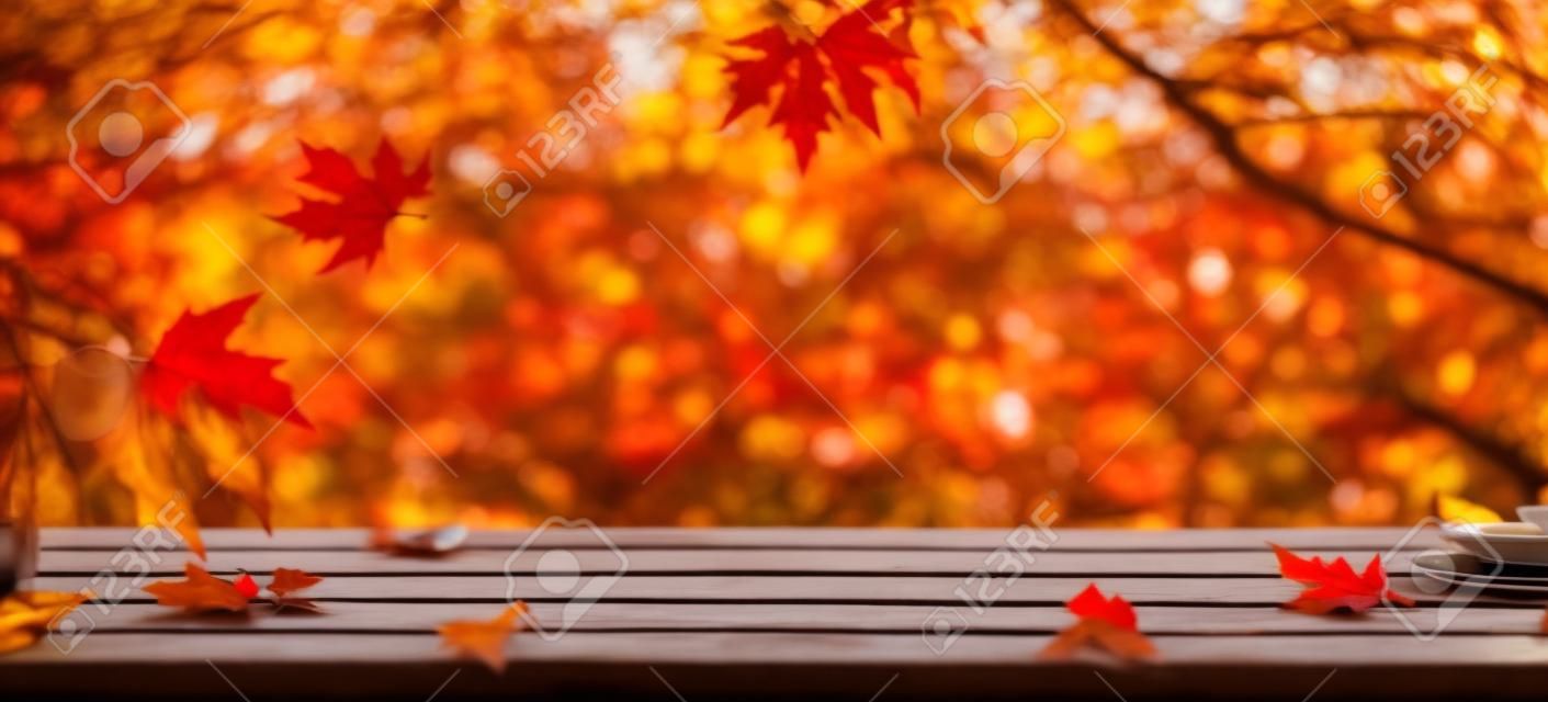 Autumn Table With Red And Yellow Leaves With Blurred Sunset Background