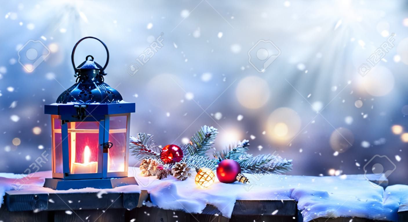 Christmas Lantern With Fir Branch and Decoration On Snowy Table