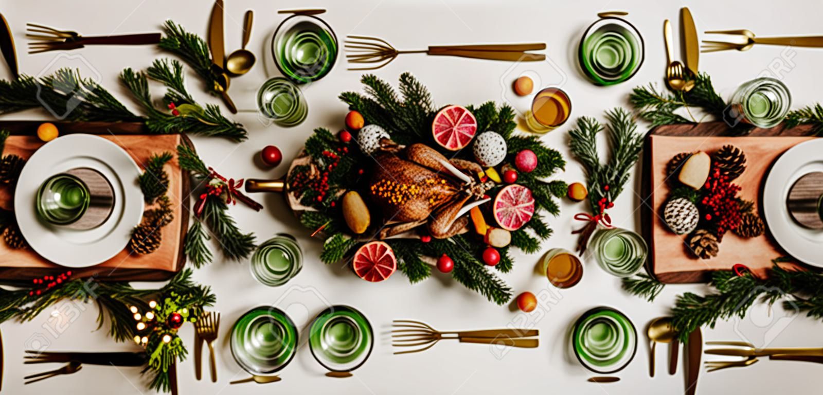Flat-lay of Festive Christmas table setting over white background