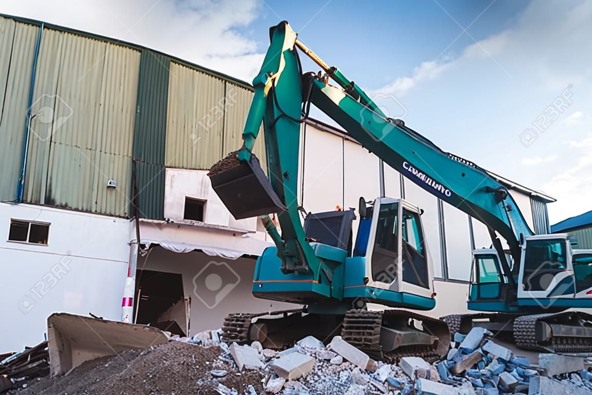 Excavators machine in construction site demolishing existing building for Renovation and new construction project