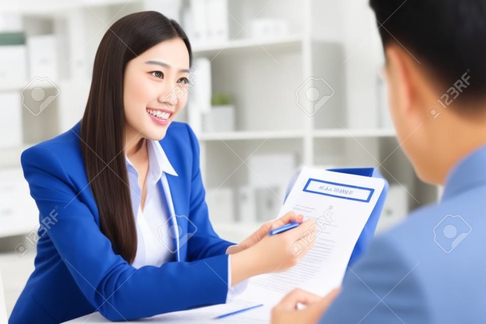 Salesmen are letting the male customers sign the sales contract, Asian women and men are doing business in the office, Business concept and contract signing	