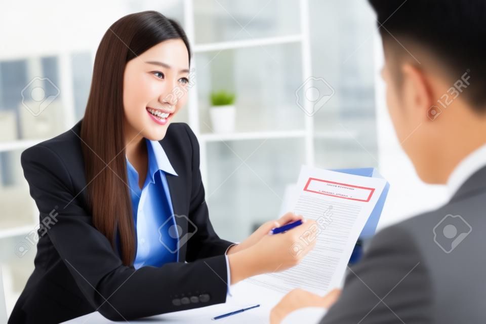 Salesmen are letting the male customers sign the sales contract, Asian women and men are doing business in the office, Business concept and contract signing	