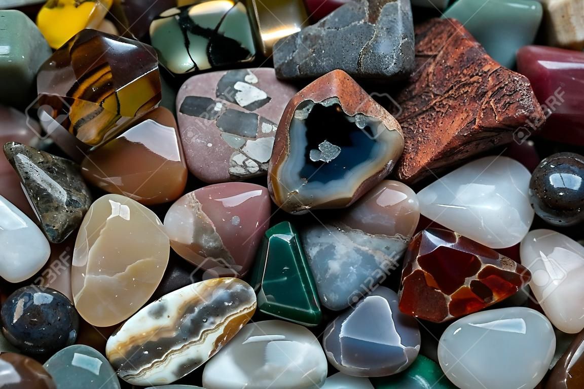 Close up of many different size, shape and colored tumbled stones