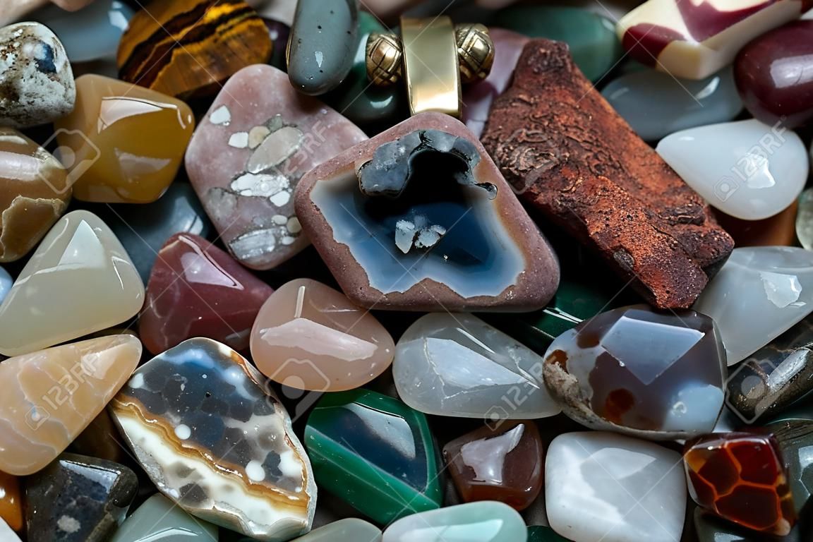 Close up of many different size, shape and colored tumbled stones