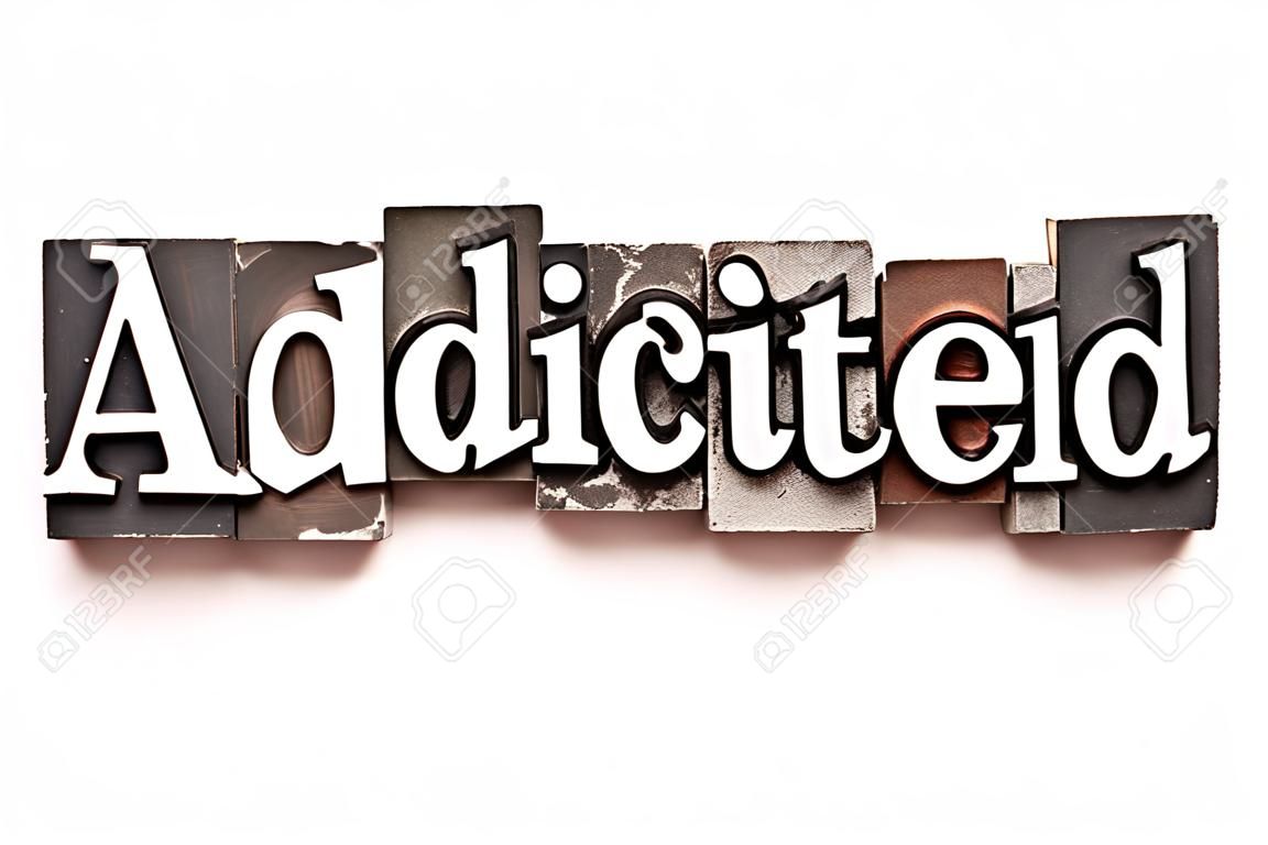 The word Addicted photographed using vintage letterpress type