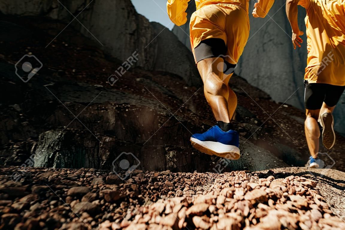 dynamic running on mountain trail legs male runner