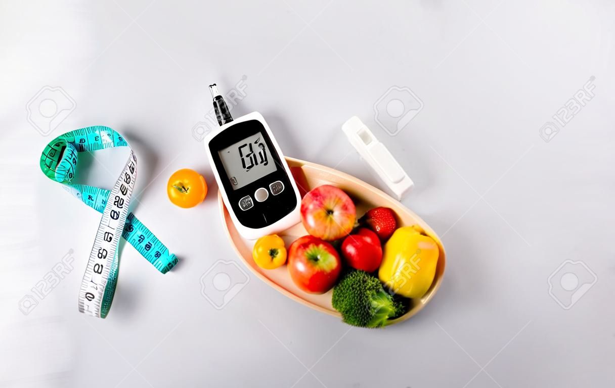 World diabetes day and healthcare concept. Diabetic measurement set, measure tape and healthy food eating nutrition in plate on stone background.