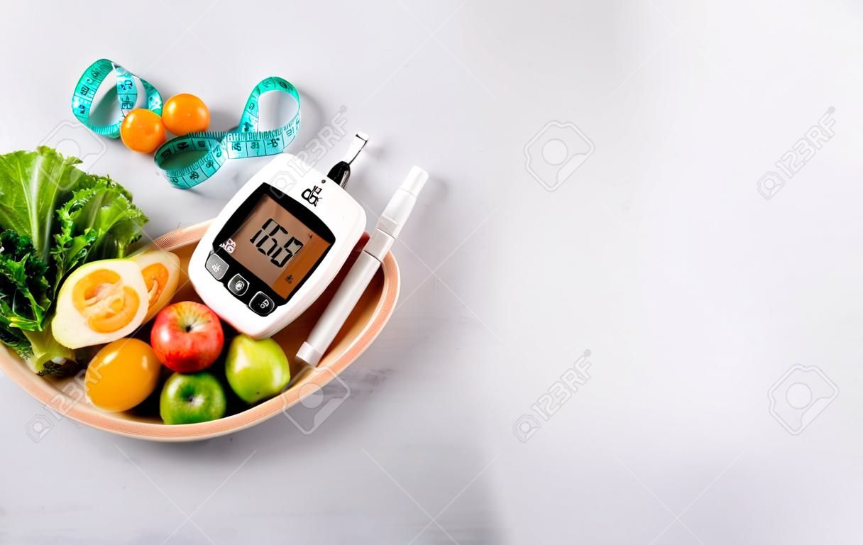 World diabetes day and healthcare concept. Diabetic measurement set, measure tape and healthy food eating nutrition in plate on stone background.