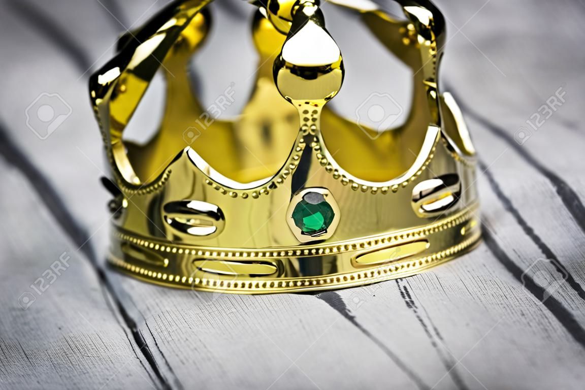 Gold crown lying on the suit of a businessman.