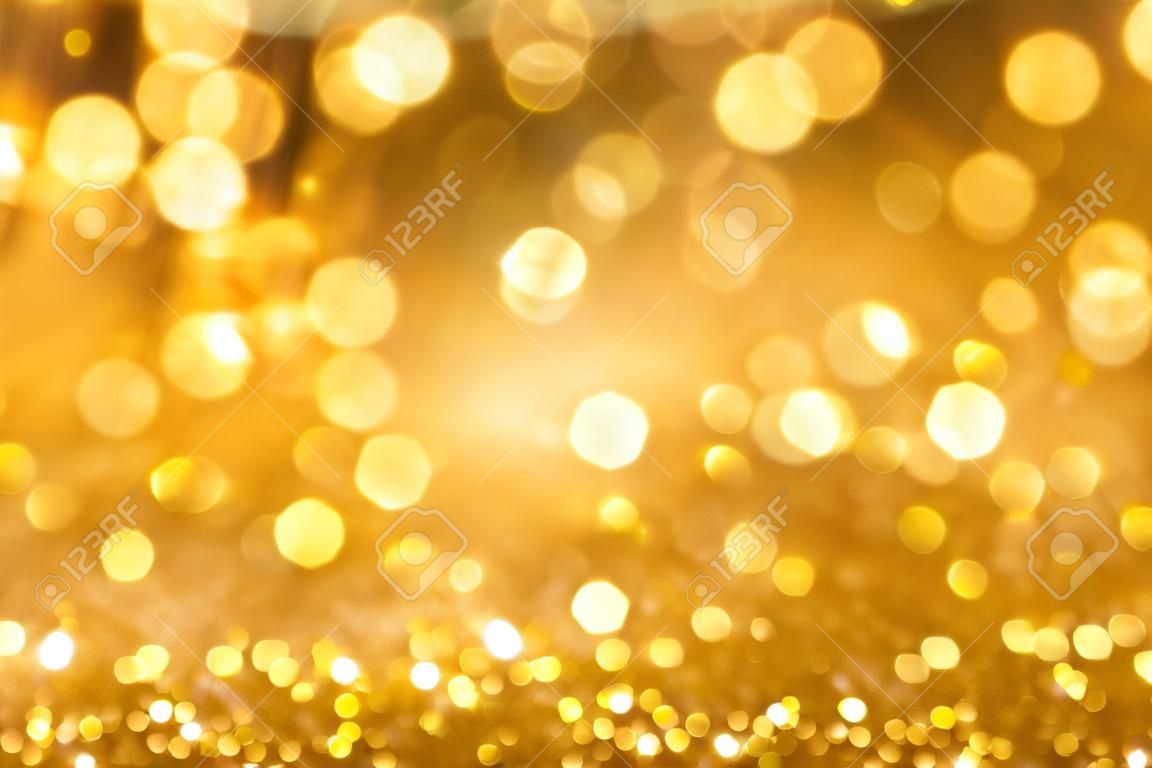 Abstract bokeh of sparkling gold glitter background or wallpaper