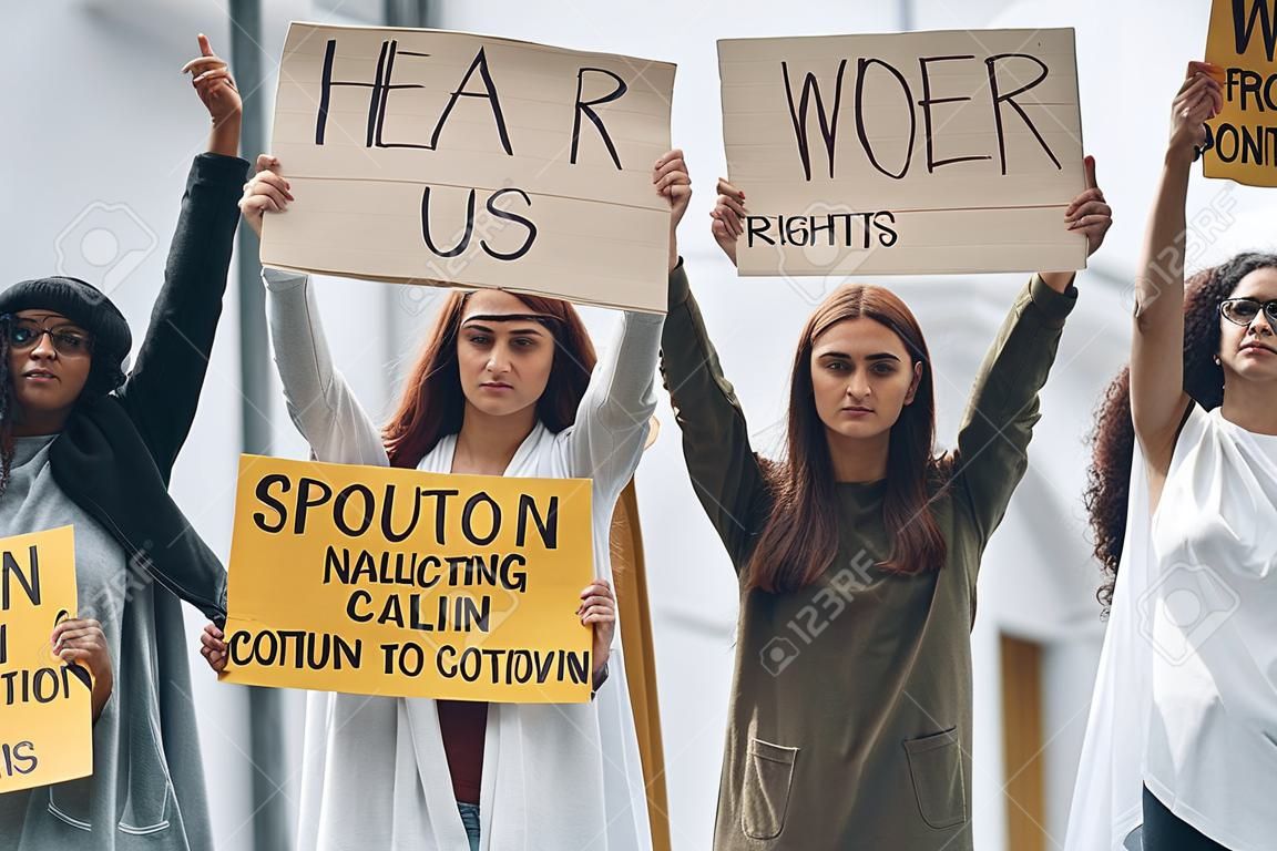 Hear us. Group of feminist women have protest for their rights outdoors.
