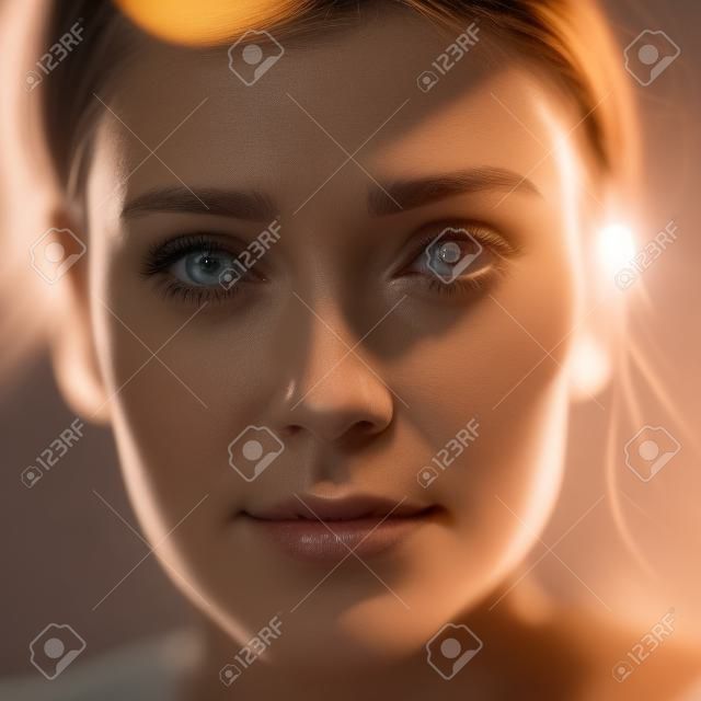 A close up of a woman"s face with light coming through her eyes. AI generative image.