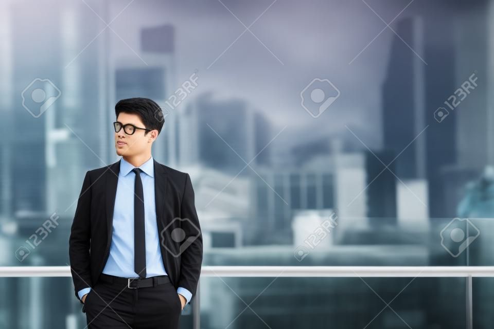 Portrait of businessman in black suit in city finding job during crisis