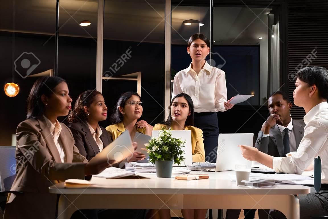 Six office worker meeting at night