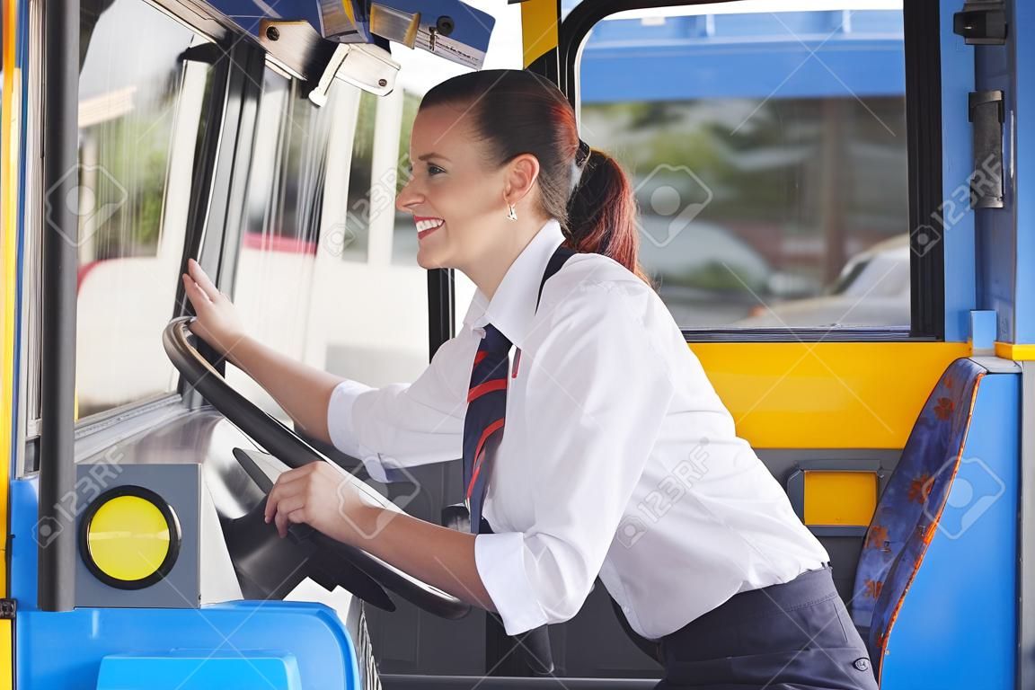 Portrait Of Female Bus Driver Behind Wheel
